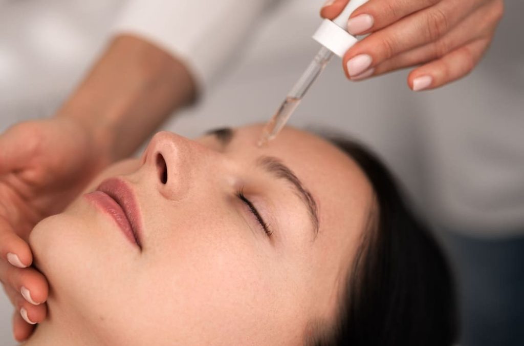 crop-beautician-applying-serum-on-face-of-female-c-2025-03-13-14-46-50-utc